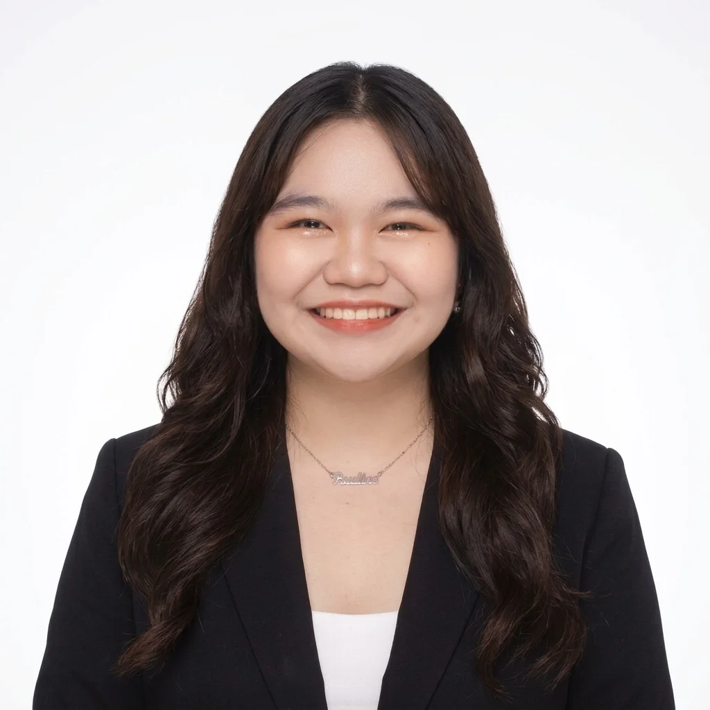 A professional headshot of a person smiling against a neutral background.