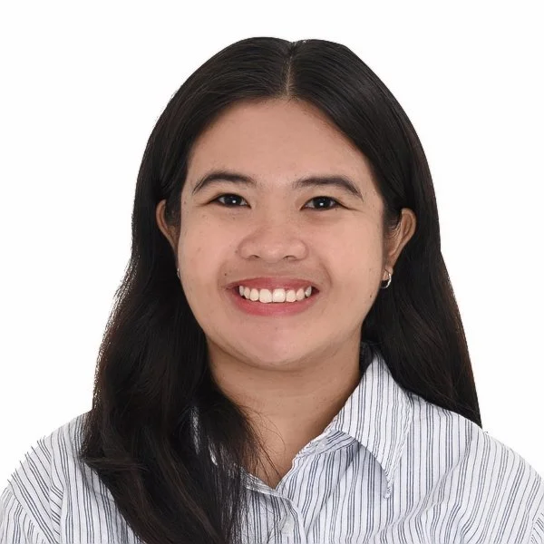 A professional headshot of a person smiling against a neutral background.