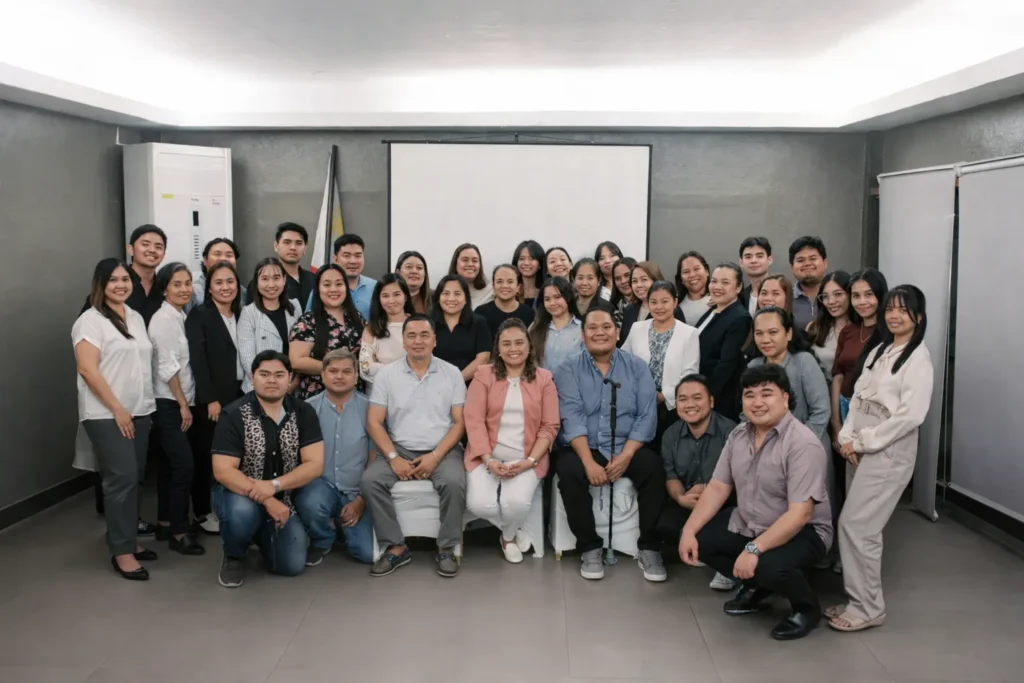 A broad group photograph of Virtual360 employees gathered inside a modern conference room.